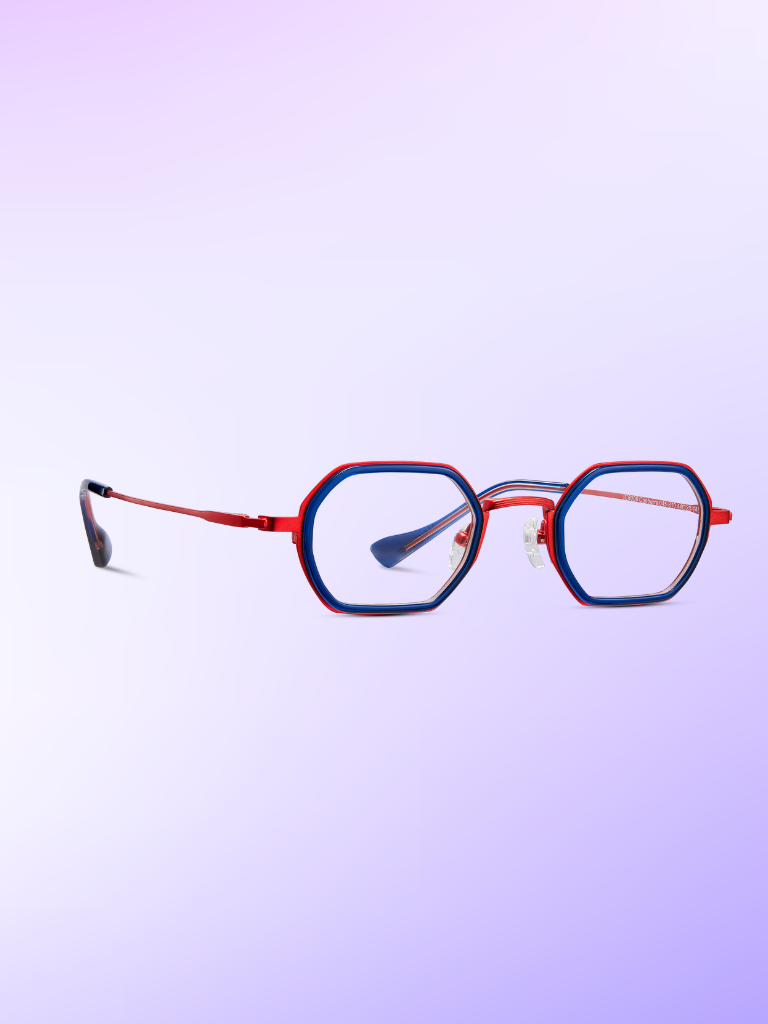 Red and blue hexagonal eyeglasses with thin metal frames are displayed on a light purple gradient background.
